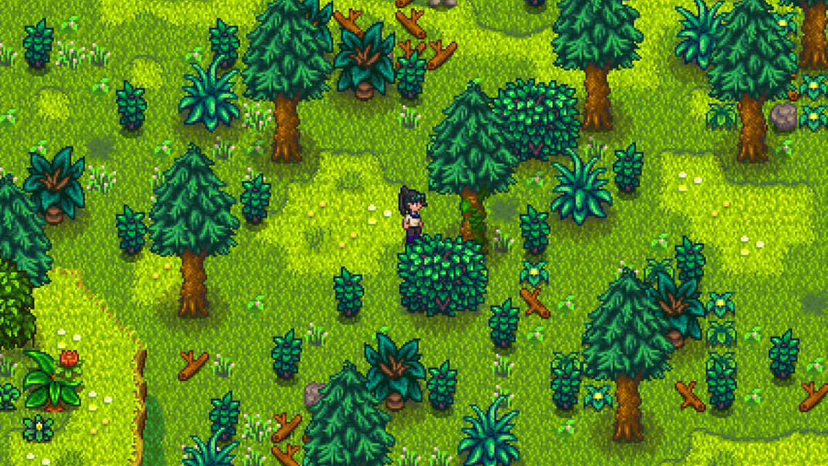 A Stardew Valley farmer stands in front of a mossy tree in the forest