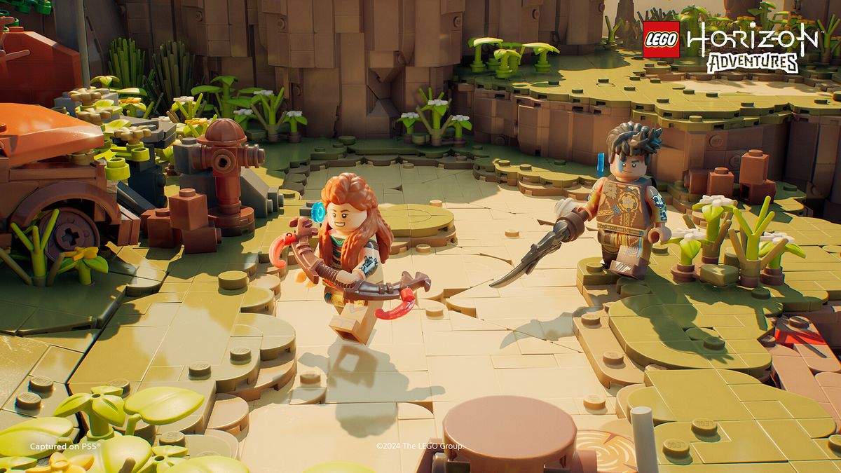 Aloy and Varl run through a Lego version of a field in a screenshot Lego Horizon Adventures